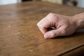 Person knocking on wood for good luck